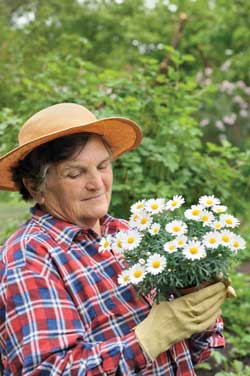 a photo of an elderly woman holding flowers