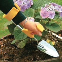 a photo of a woman wearing a gardening shovel attached to an arm brace
